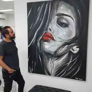 סטודיו בזכרון יעקב. מוטי גראו עומד ליד תמונה